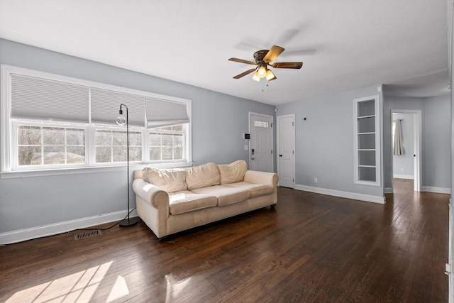 living room featuring ceiling fan and dark hardwood / wood-style flooring