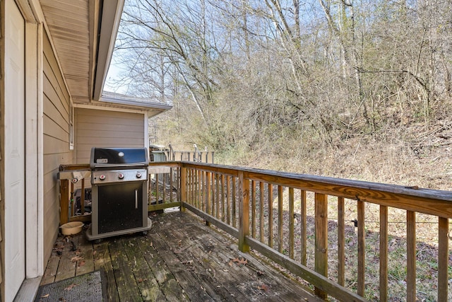 wooden deck with a grill