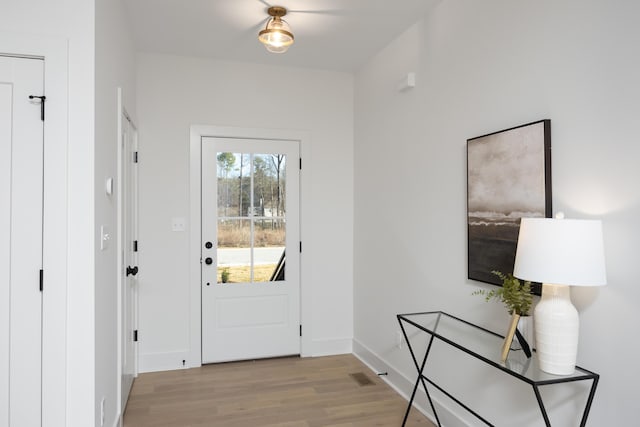 doorway to outside with light wood-type flooring