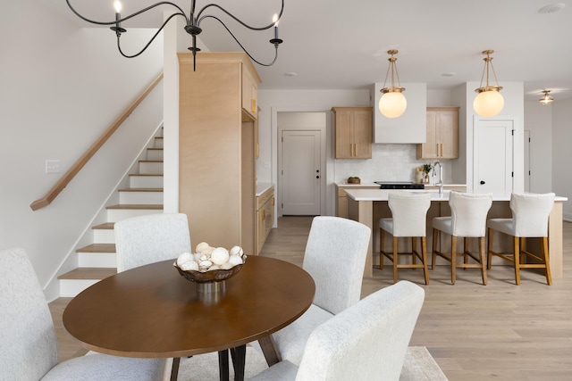 dining room with sink and light hardwood / wood-style flooring