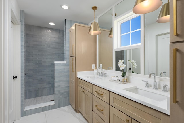 bathroom with vanity and a tile shower