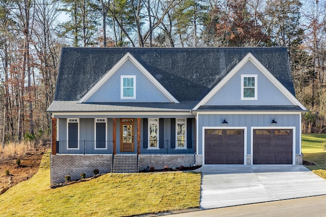 view of front facade with concrete driveway, a porch, a front lawn, and board and batten siding