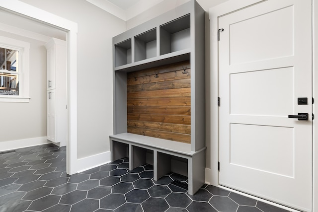 mudroom with visible vents, baseboards, a sauna, dark tile patterned floors, and built in shelves