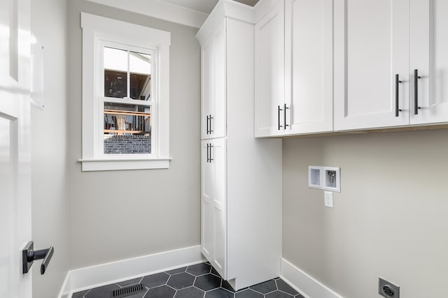 washroom featuring hookup for a washing machine, cabinet space, baseboards, and hookup for an electric dryer