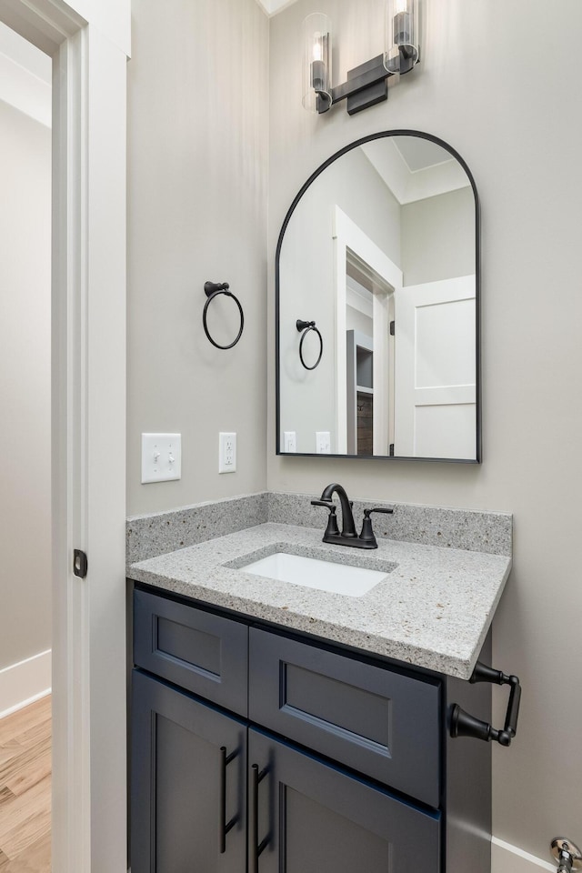 bathroom with vanity and wood finished floors