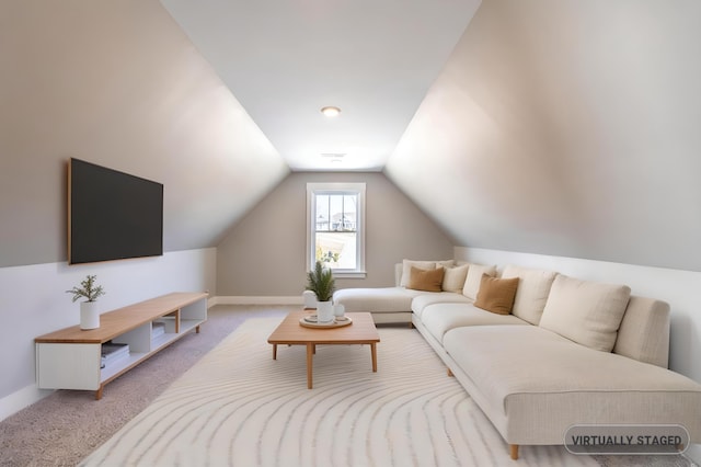 living room with lofted ceiling, baseboards, and light colored carpet