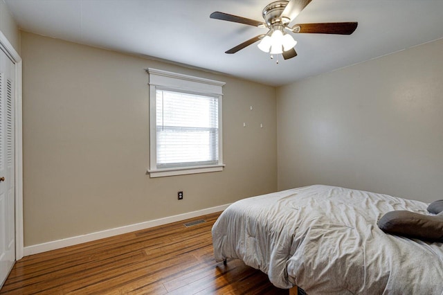 bedroom with ceiling fan, hardwood / wood-style floors, and a closet