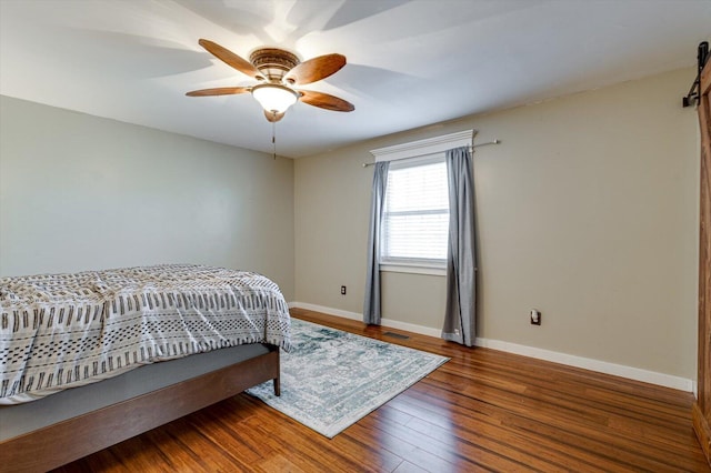 bedroom with hardwood / wood-style floors and ceiling fan