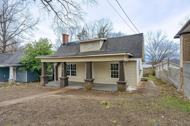 bungalow with a porch and a patio