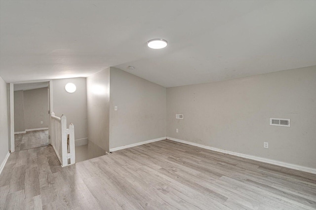 bonus room with light wood-type flooring