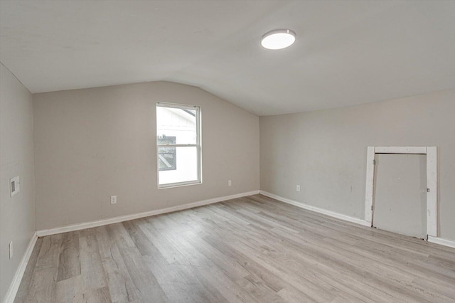 bonus room with lofted ceiling and light hardwood / wood-style flooring