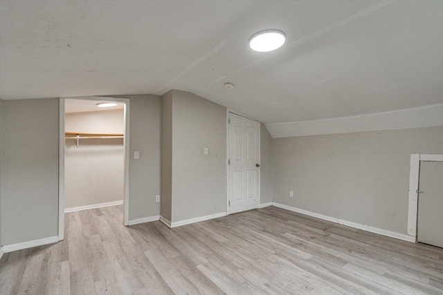 bonus room with vaulted ceiling and light hardwood / wood-style floors