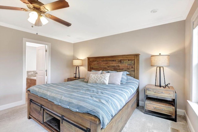 carpeted bedroom featuring crown molding, ceiling fan, and ensuite bath