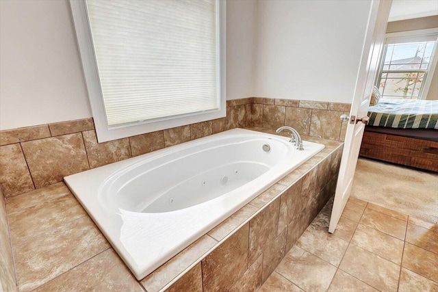 bathroom featuring tile patterned flooring and tiled bath