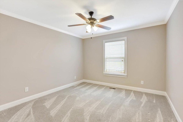 unfurnished room with crown molding, ceiling fan, and carpet