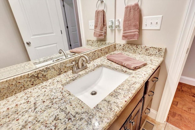 bathroom featuring vanity and hardwood / wood-style floors