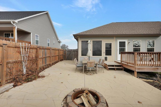 back of house with a patio, a deck, and a fire pit