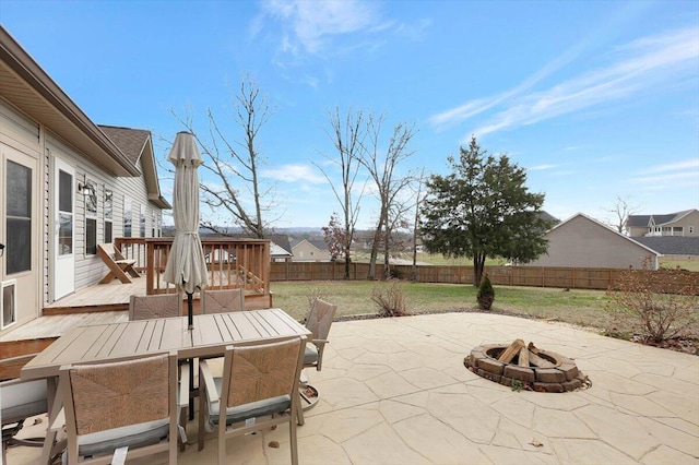 view of patio / terrace featuring a wooden deck and a fire pit