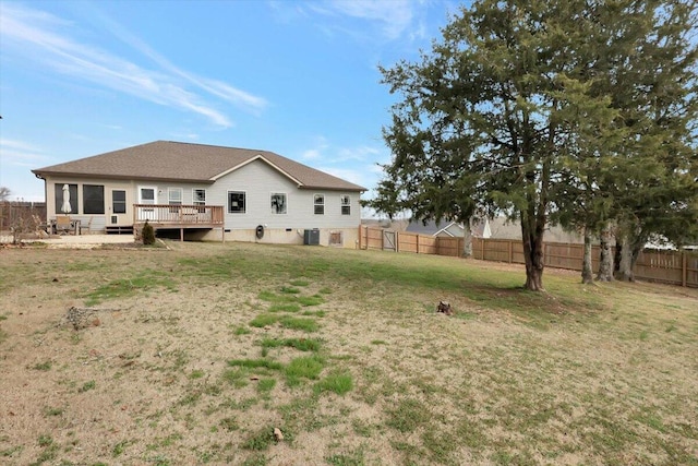 view of yard with a wooden deck and central air condition unit