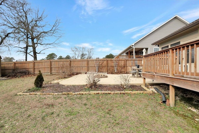 view of yard featuring a wooden deck and a patio