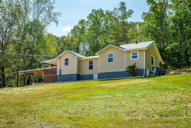 view of property exterior with a lawn and a deck