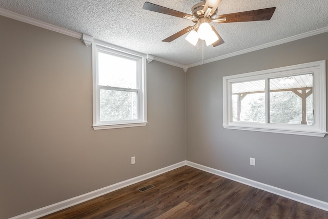 spare room featuring dark wood-type flooring, plenty of natural light, crown molding, and a textured ceiling