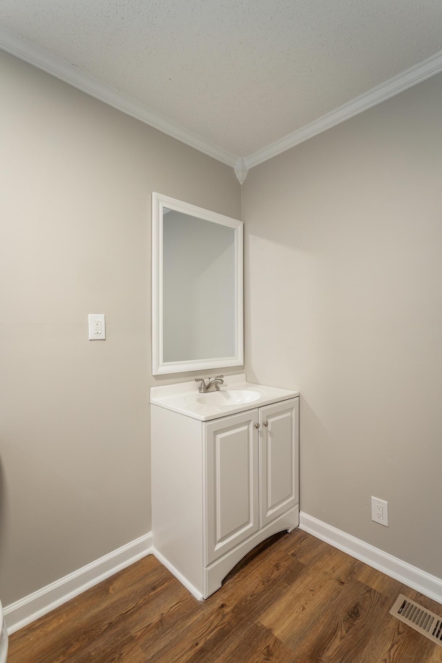 interior space featuring crown molding, sink, and dark wood-type flooring