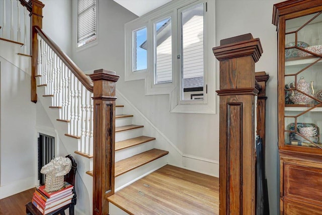 staircase with hardwood / wood-style floors