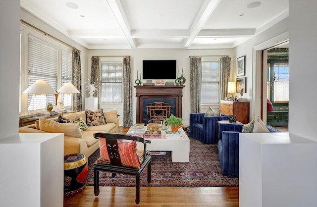 living room with wood-type flooring, coffered ceiling, and beam ceiling