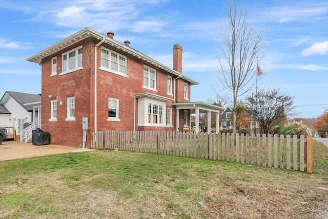 view of property exterior featuring a patio and a lawn