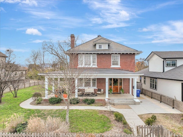 view of front of house with a front lawn and a patio