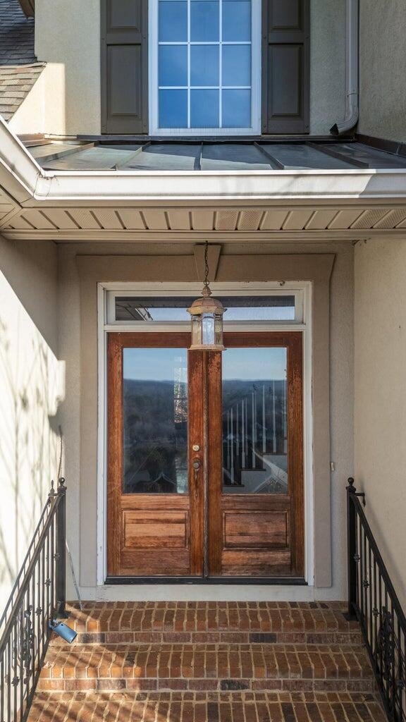 view of exterior entry featuring french doors