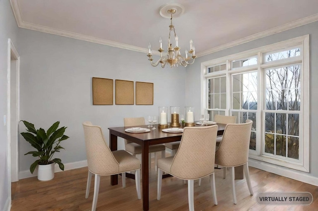 dining room with an inviting chandelier, wood-type flooring, and ornamental molding