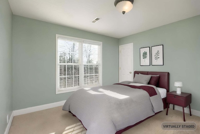 bedroom featuring light carpet