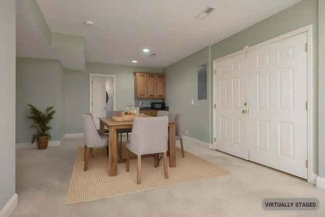 carpeted dining space featuring electric panel