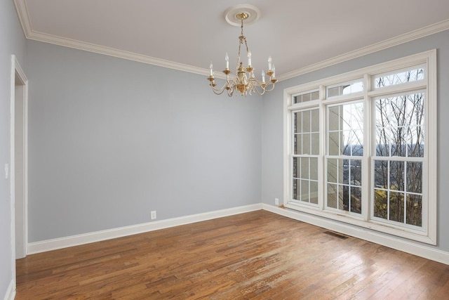 unfurnished room featuring crown molding, wood-type flooring, and a chandelier