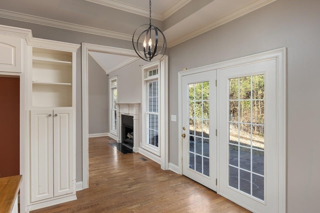 interior space with crown molding, dark hardwood / wood-style flooring, and a notable chandelier