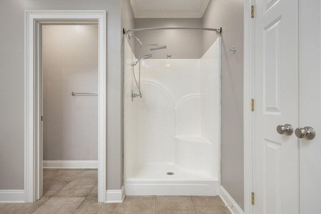 bathroom with ornamental molding, tile patterned flooring, and a shower