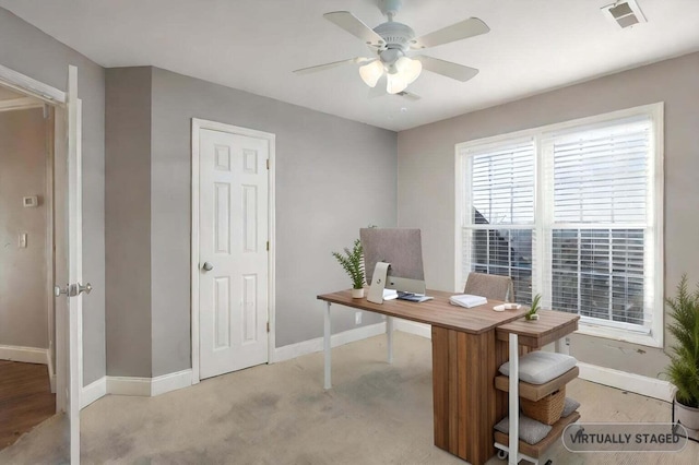 home office featuring ceiling fan and light carpet