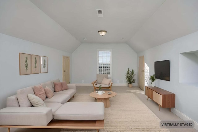 carpeted living room featuring vaulted ceiling