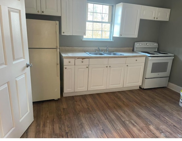 kitchen featuring dark hardwood / wood-style flooring, sink, white appliances, and white cabinets