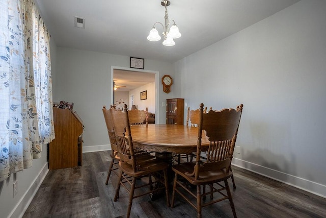 dining area featuring dark hardwood / wood-style flooring and an inviting chandelier