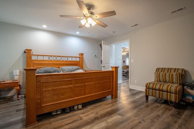 bedroom with ceiling fan and dark hardwood / wood-style flooring