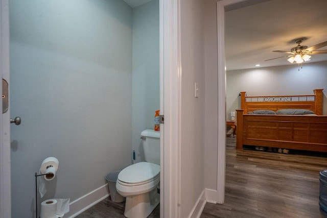 bathroom featuring hardwood / wood-style flooring, ceiling fan, and toilet