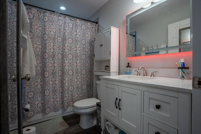 bathroom with vanity, wood-type flooring, and toilet