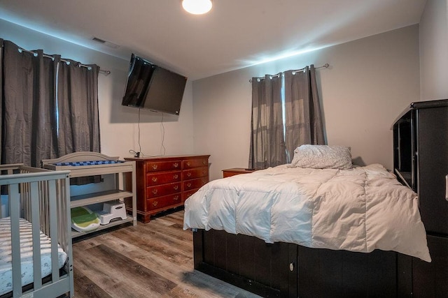 bedroom with hardwood / wood-style flooring