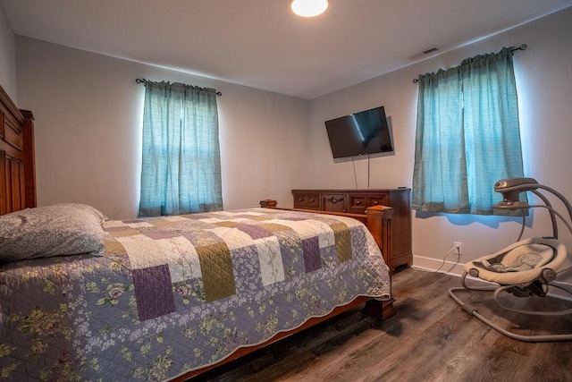 bedroom with dark wood-type flooring