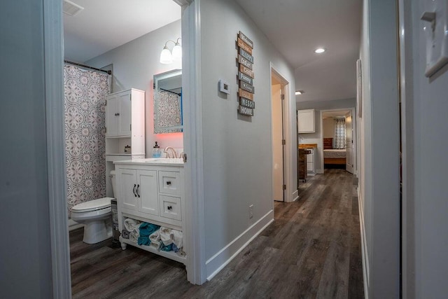 bathroom featuring hardwood / wood-style flooring, vanity, and toilet