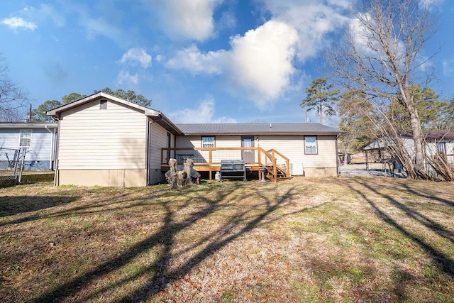 back of house featuring a yard and a deck