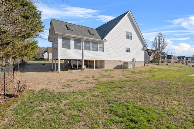 rear view of house featuring a yard